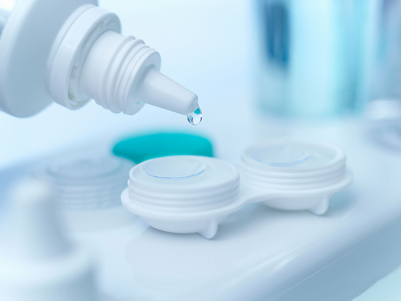 Close up of saline dropping on contact lens.