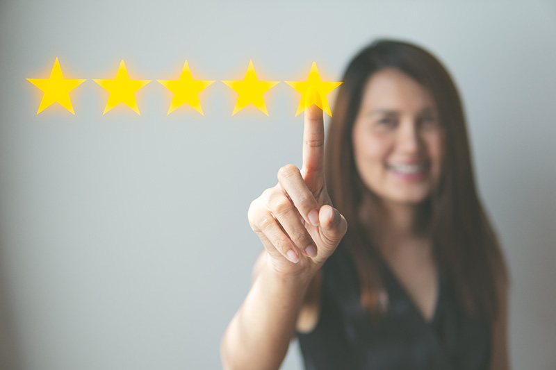 a picture of a woman pointing to five stars